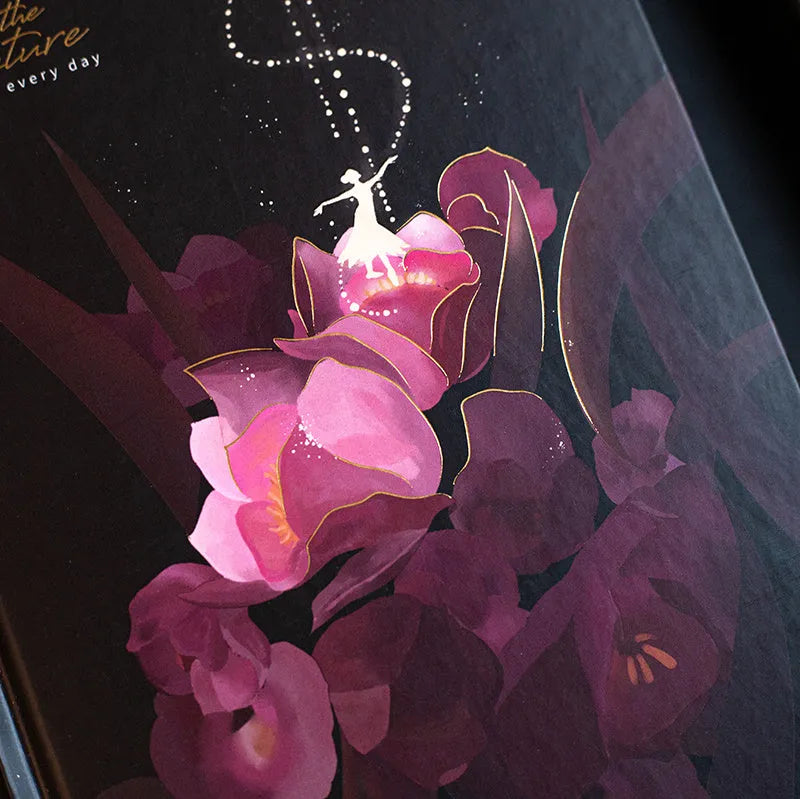 A5 notebook with luminous colourful illustration cover shown in deep blue, gold, light blue, and purple colour options.