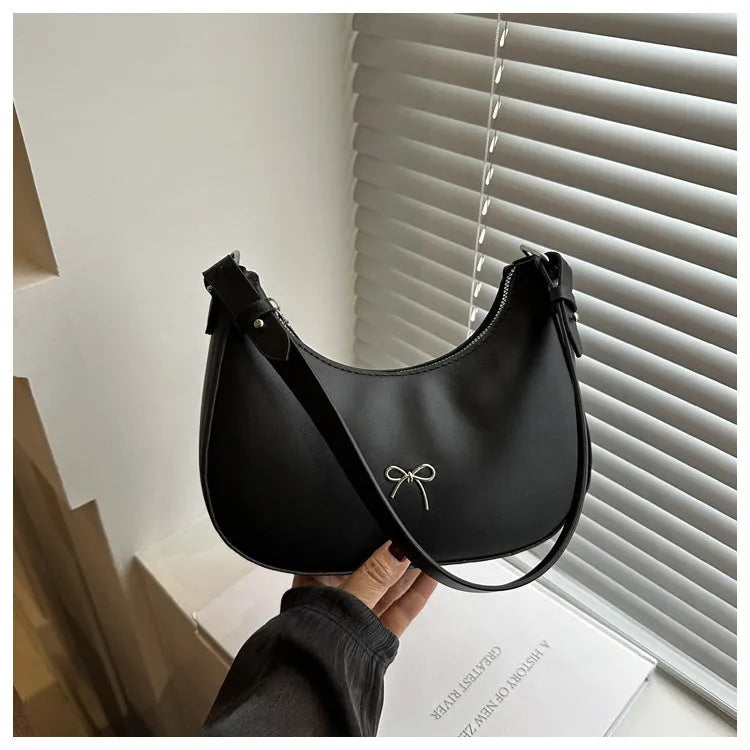 Women's underarm small bag in black PU with single shoulder strap and stitching detail