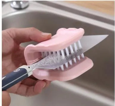 U-shaped knife and cutlery cleaner brush with ABS bristles in blue, resting on a kitchen counter