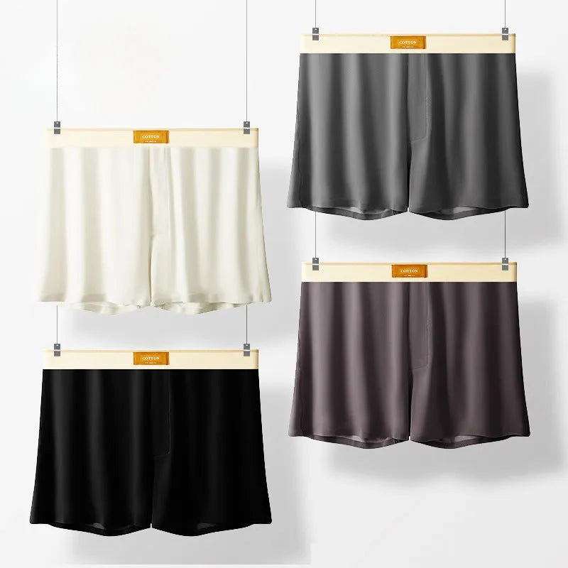 Pack of three men's solid colour loose fit ice silk boxer shorts on a mid waist.