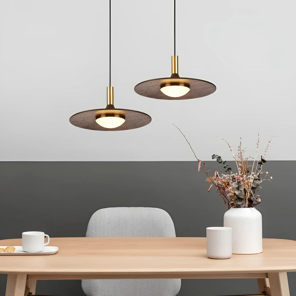 Walnut wood fish line chandelier with all-copper accents against a light background