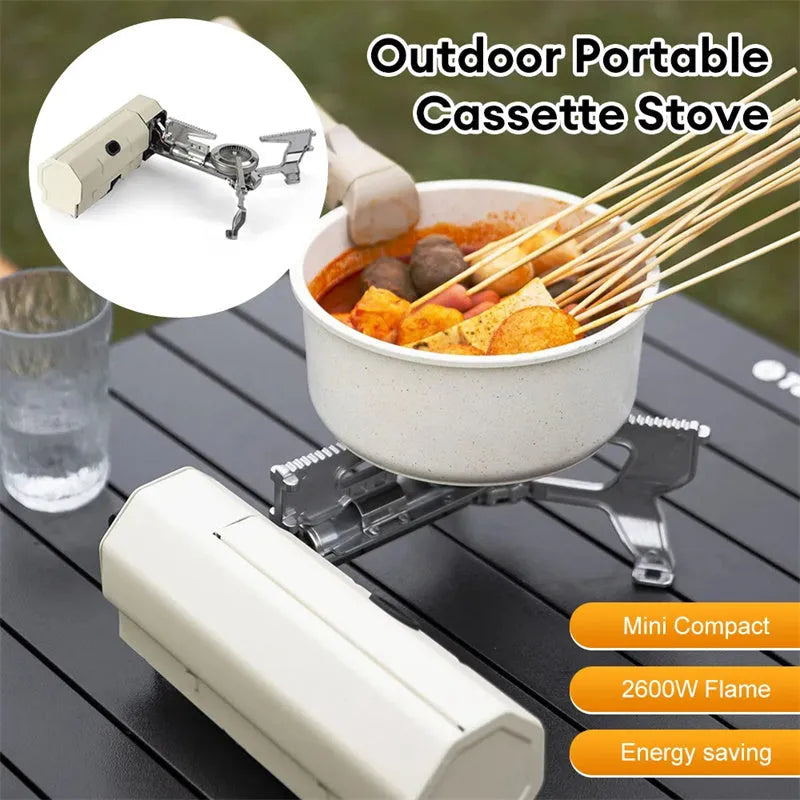 Green folding camping gas stove with burner, serrated bracket, and anti-slip feet on a tabletop