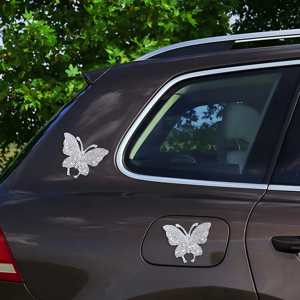 Diamond-encrusted car sticker showing bear paw and butterfly designs on glass with drill stick