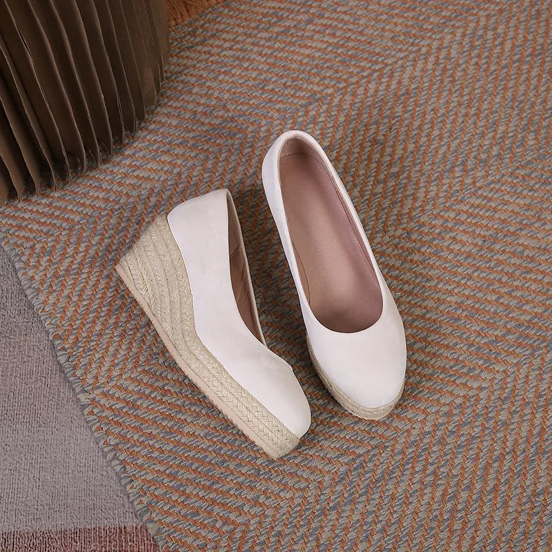 Women's wedge heel pumps with rope bottom detail in apricot colour showing shallow mouth design