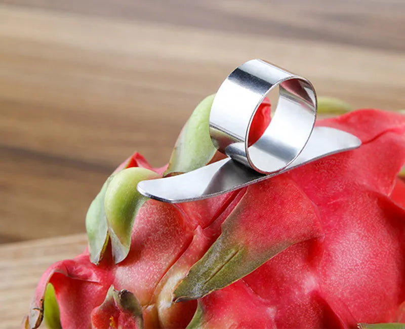 Silver stainless steel ring peeler for citrus fruits on a white background