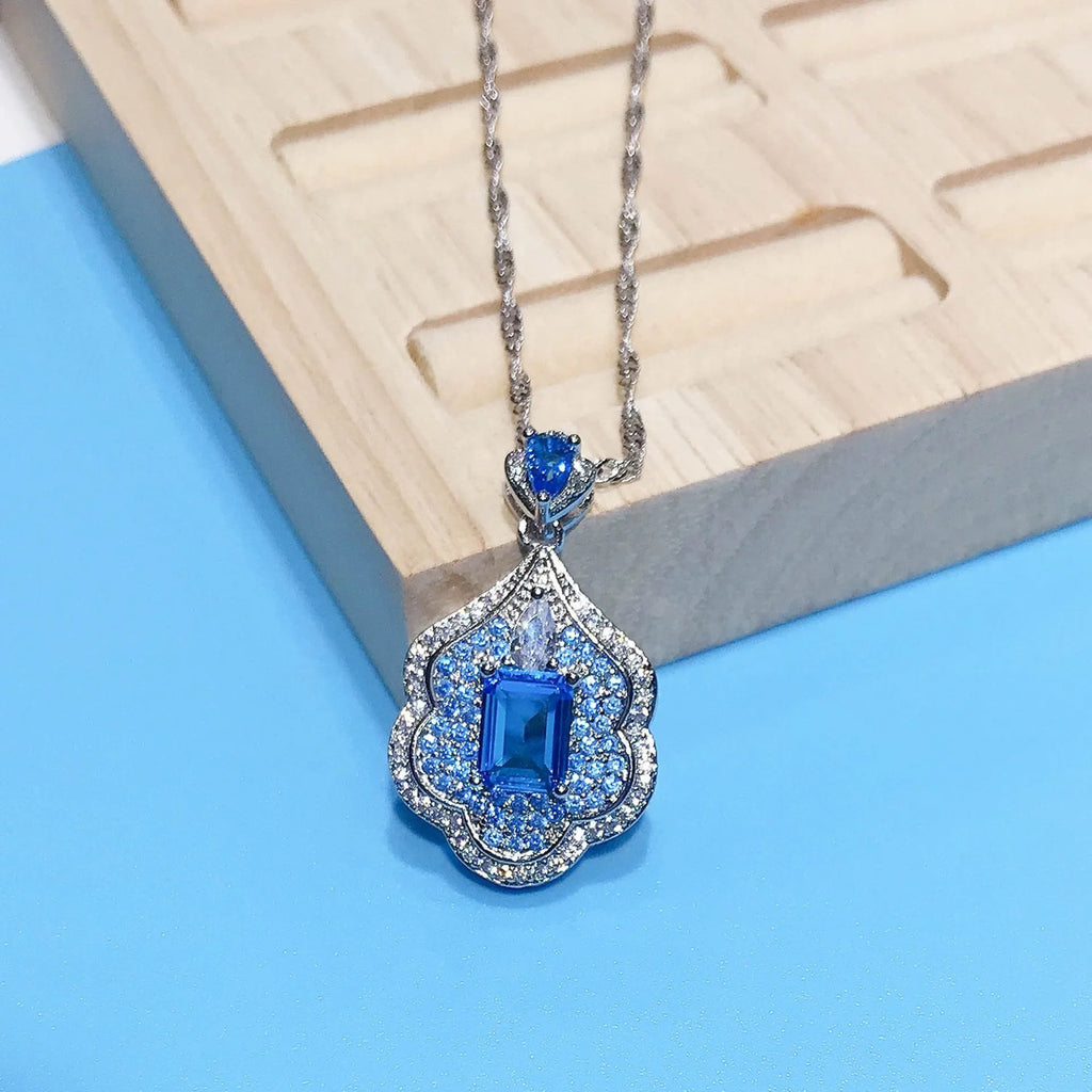 Sea blue mirror finish copper geometry pendant without chain, shown on neutral background