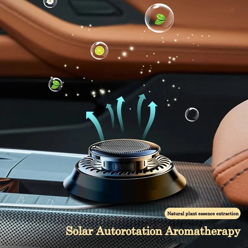 Solar-powered kinetic double ring rotating car air freshener fragrance diffuser on a car dashboard.