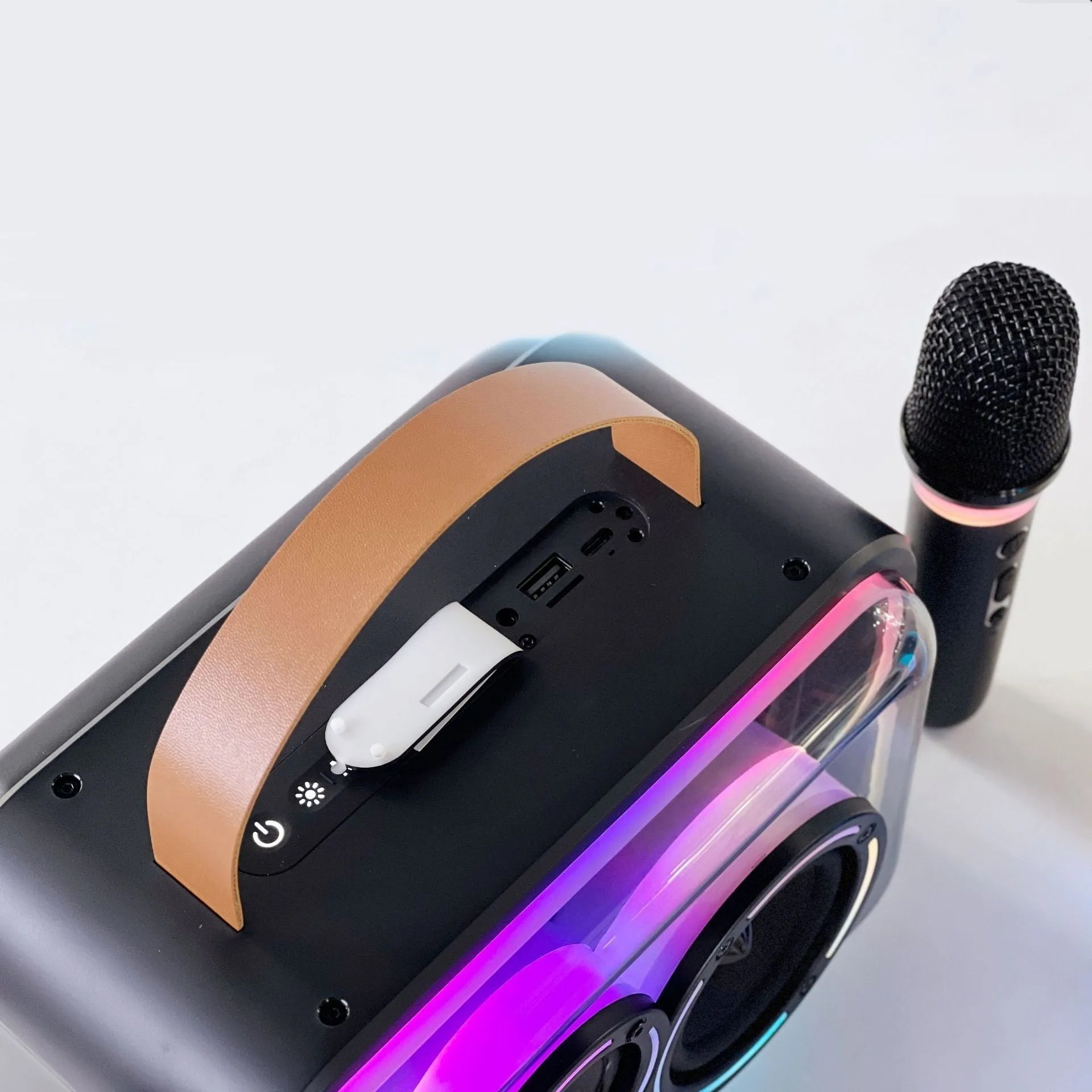 Portable Bluetooth karaoke speaker with RGB lights, black finish, showing speaker grille and control panel