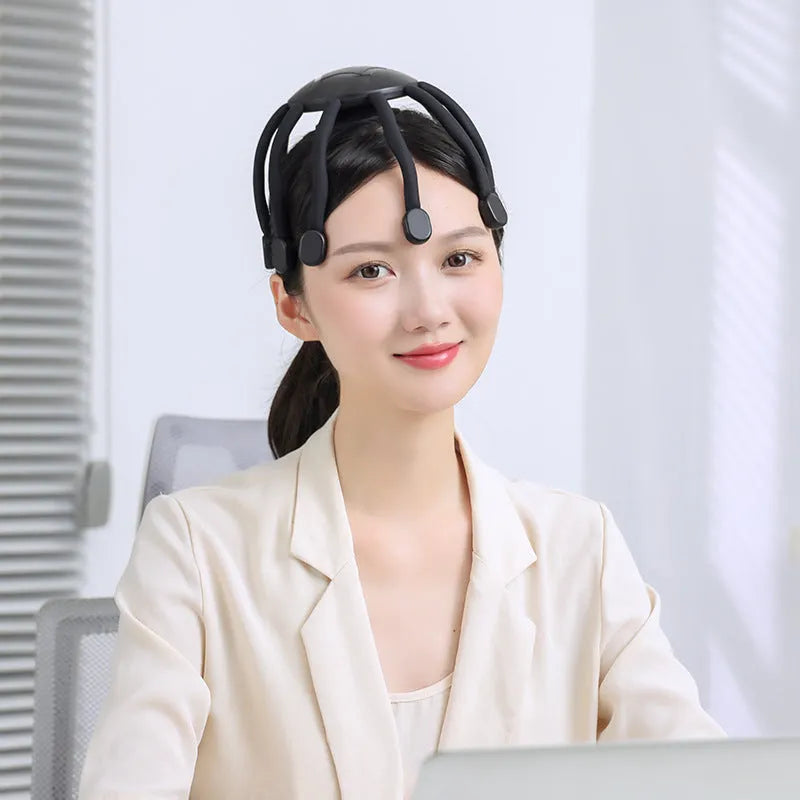 Black USB-powered electric head massager with multiple flexible claws on a white background.