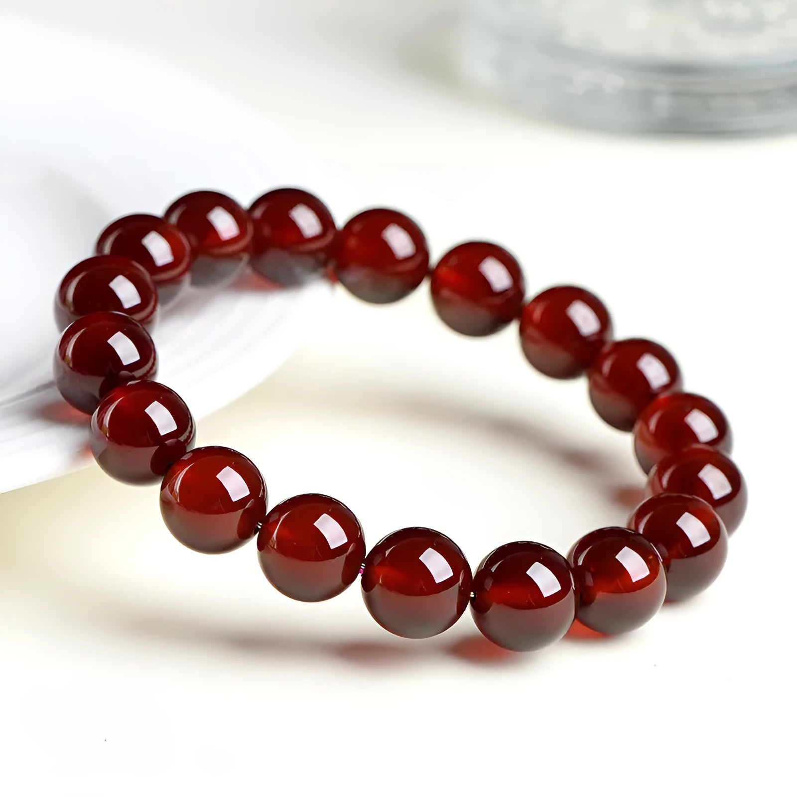 Natural orange red garnet ball bracelet with ruyi charm showing crystal construction and spherical gemstones