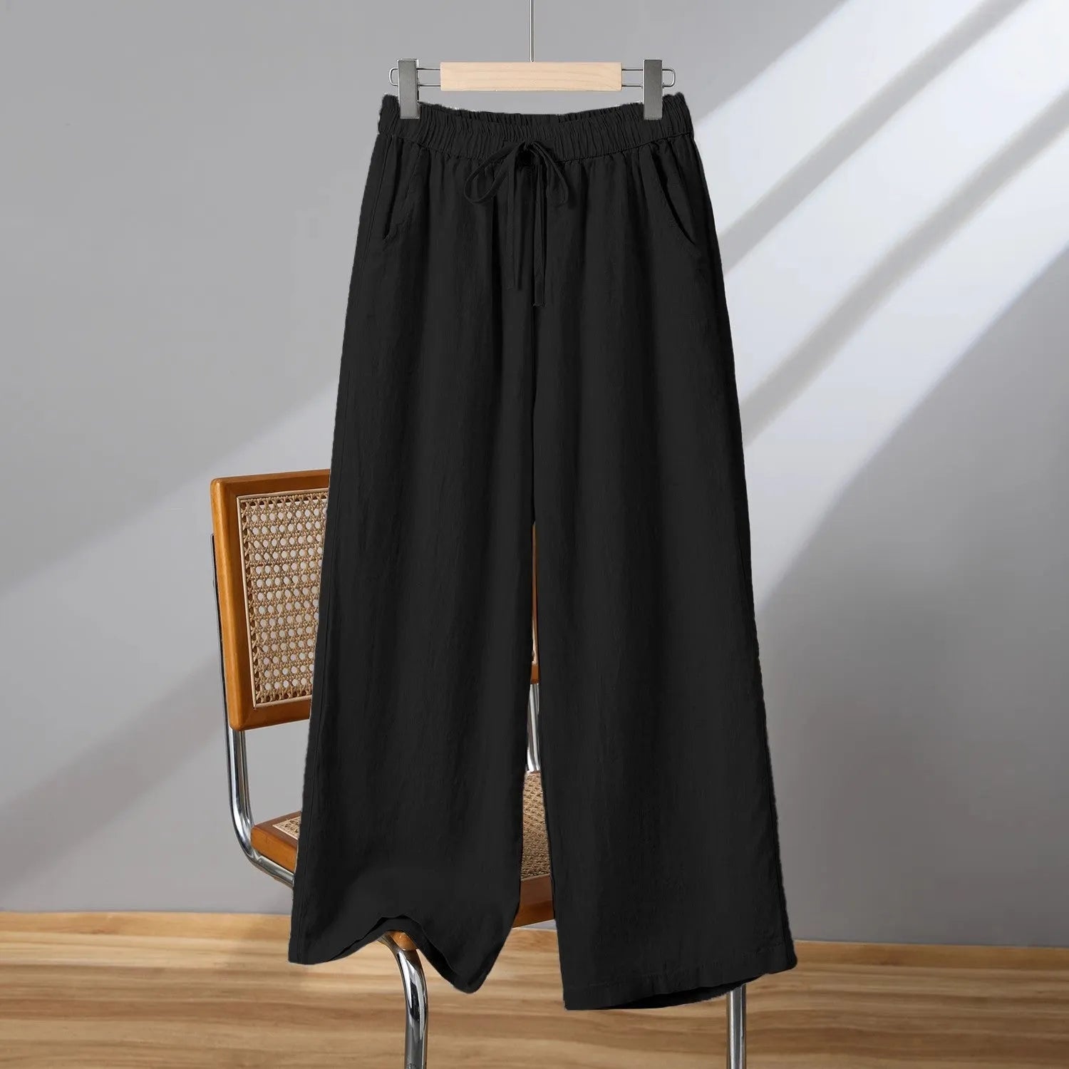 Women's apricot straight-leg casual trousers with a drawstring elastic waistband laid flat.