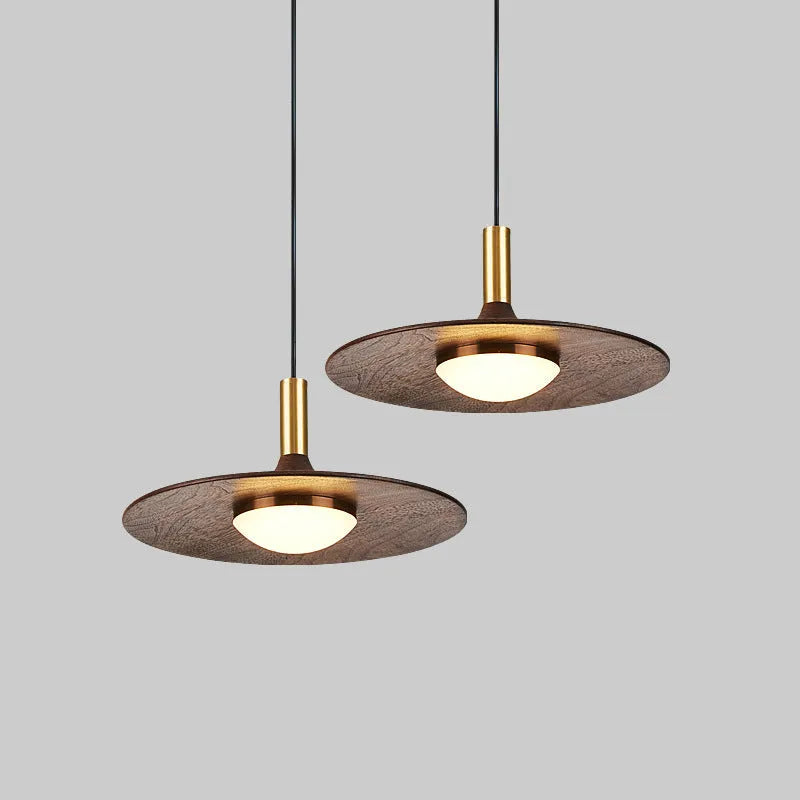 Walnut wood fish line chandelier with all-copper accents against a light background