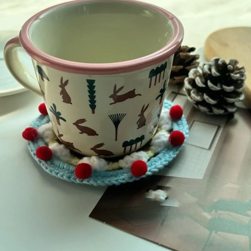 Round wool cake coaster 9cm diameter on a wooden table