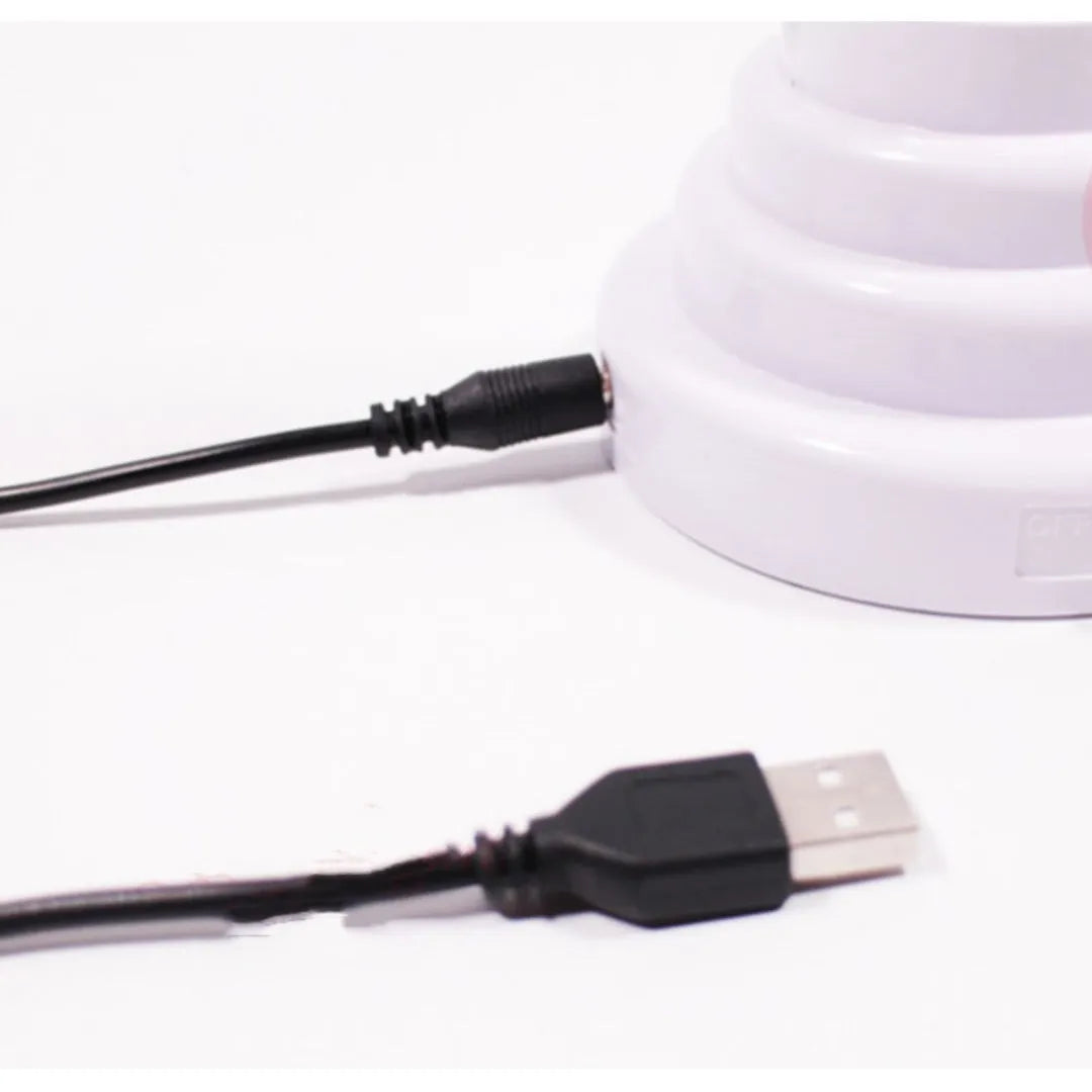 White tube bamboo shape desktop lamp emitting green light, with USB cable.
