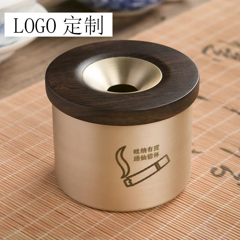Brass ashtray with wooden lid showing central aperture design