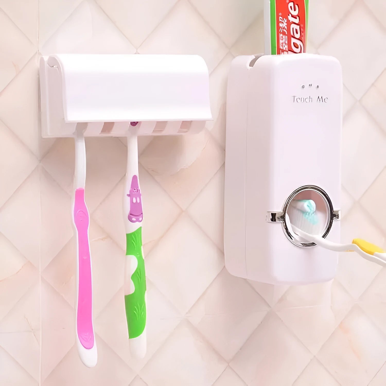 White plastic and silicone bathroom accessories set with toothbrush holder and pump dispenser on a tiled wall