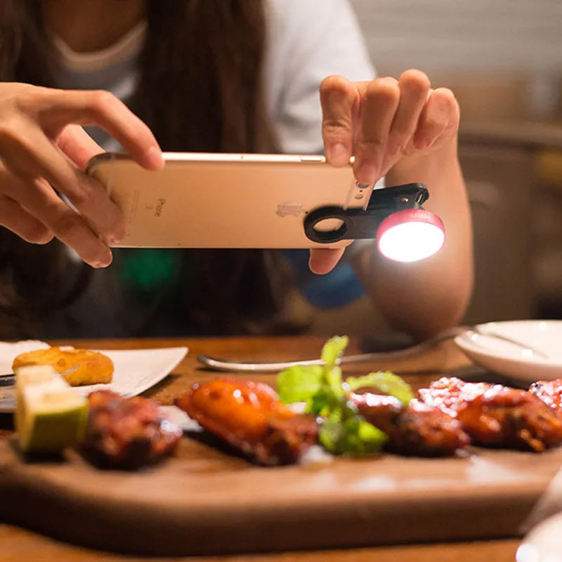 External mobile phone camera lens with wide angle and colourful light effects, black model clipped onto smartphone