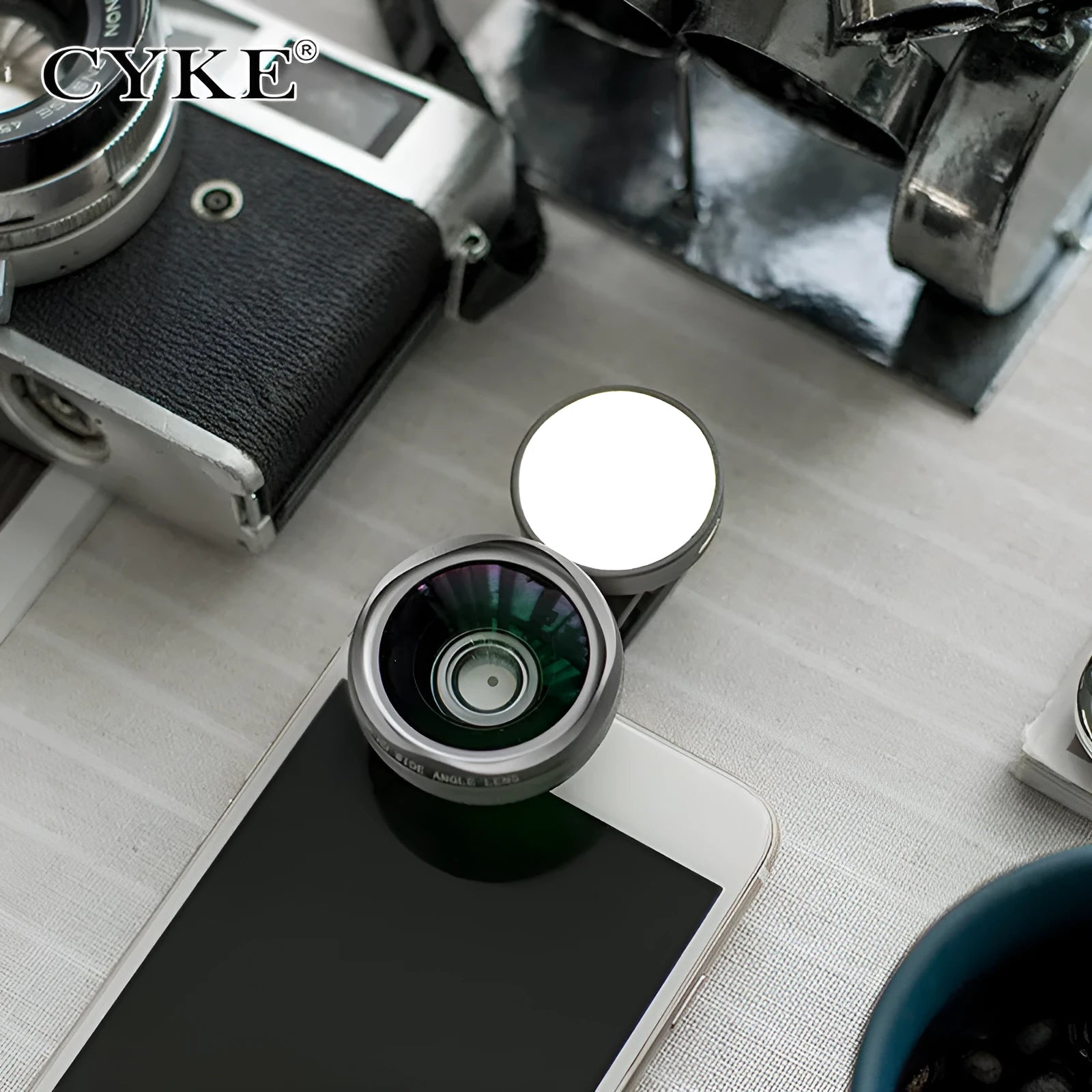 External mobile phone camera lens with wide angle and colourful light effects, black model clipped onto smartphone