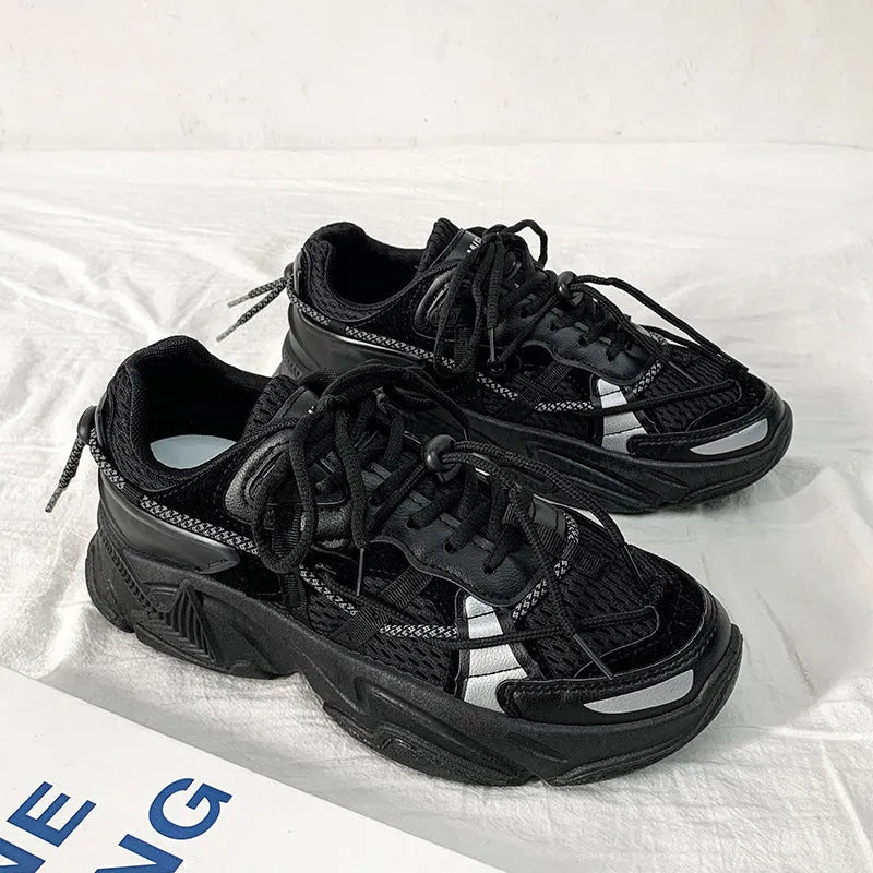 Men's white, black, and grey platform dad shoes with thick soles and lace-up front.