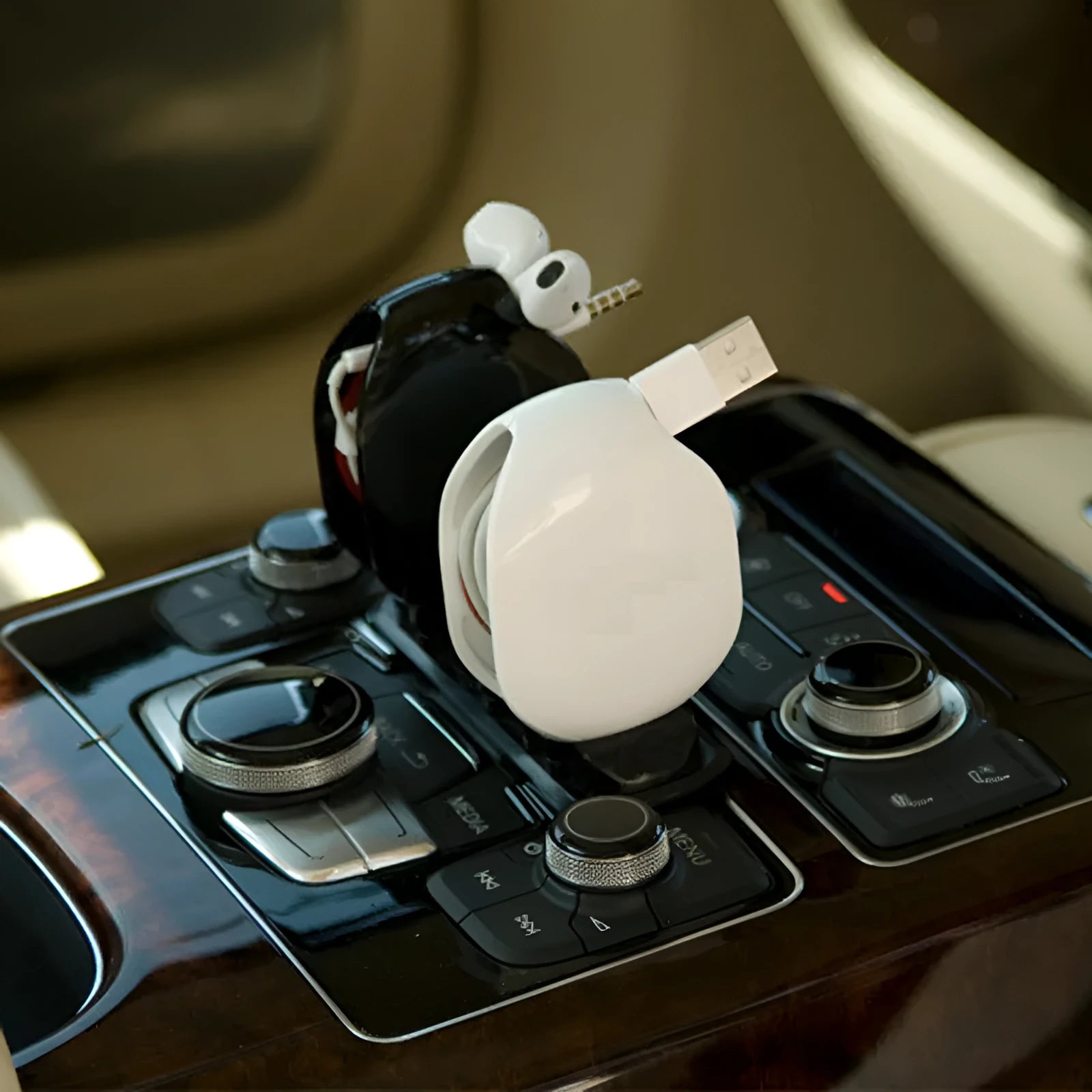Automatic earphone cable winder retractor in multiple colours showing compact size