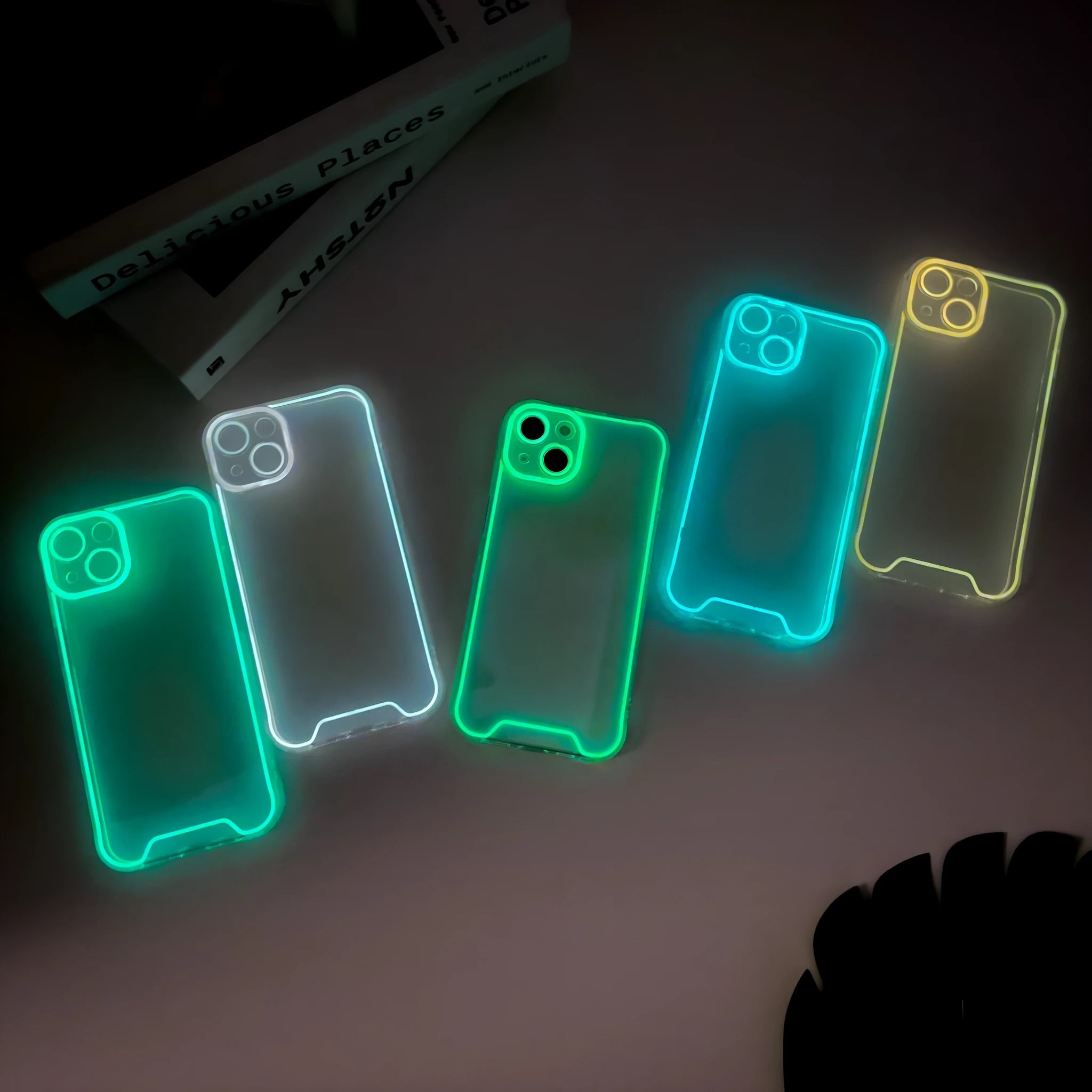 Glow in the dark green soft TPU phone case for iPhone on a dark background.