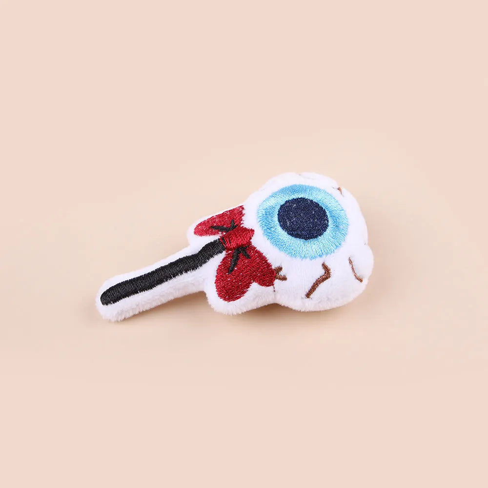 Small plush cat teaser wand with replaceable candy and skull head designs for interactive feline play
