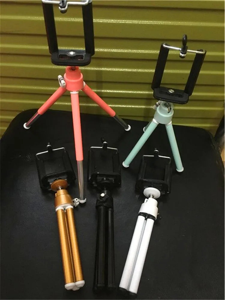 Black desktop phone holder with two-section metal bracket on office desk
