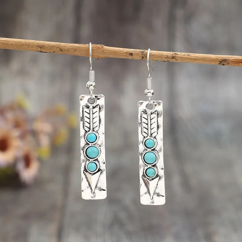 Silver geometric long drop earrings with turquoise inlay on a retro-style zinc alloy setting.