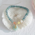 Natural blue water jade bead bracelet with gourd peace buckle design on white background
