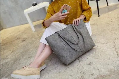 A simple fashion shoulder bag and handbag for spring summer, shown in black and grey colour options.