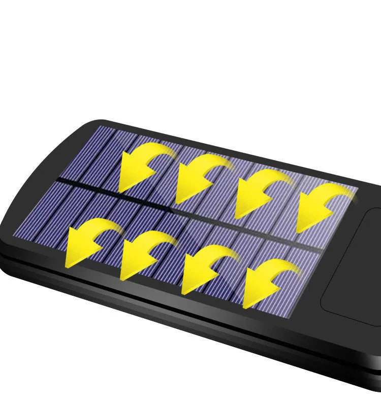 Black outdoor solar-powered motion sensor light mounted on a wall with solar panel visible.