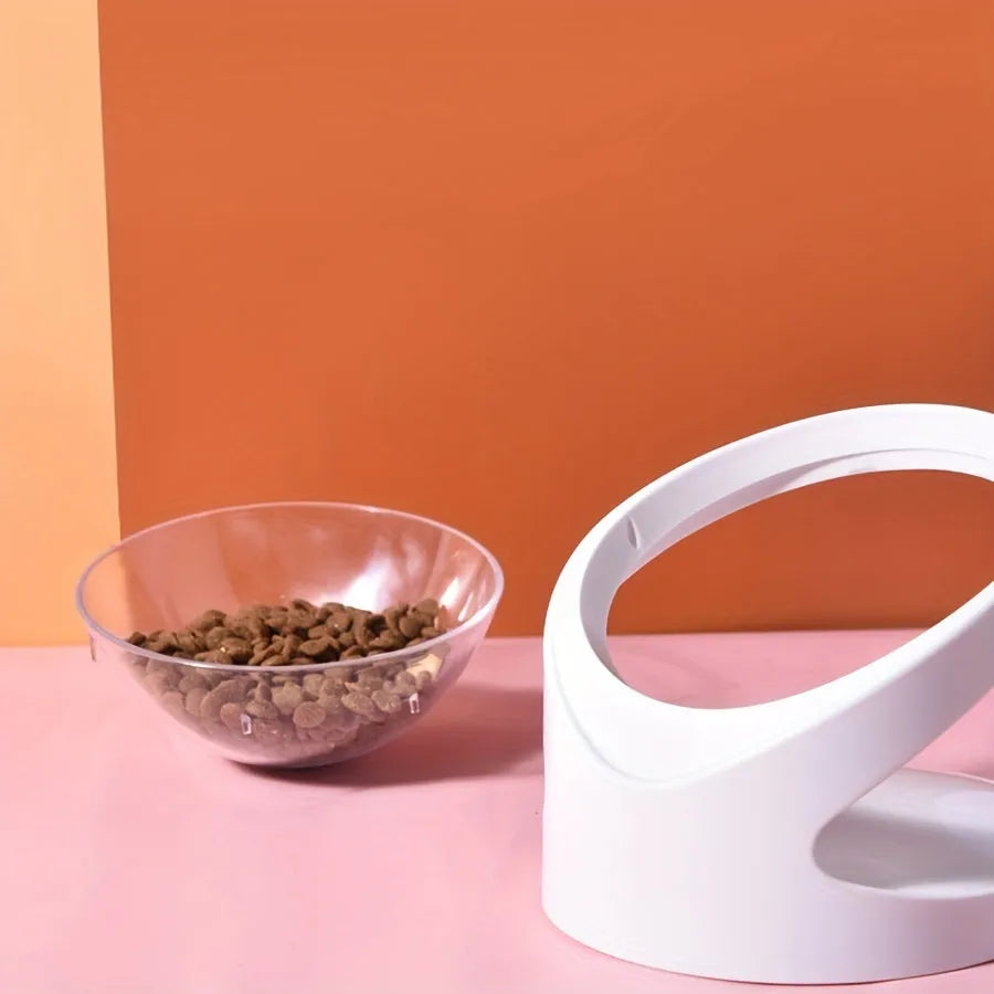 Clear plastic elevated cat food bowl with 15-degree tilt angle on white background