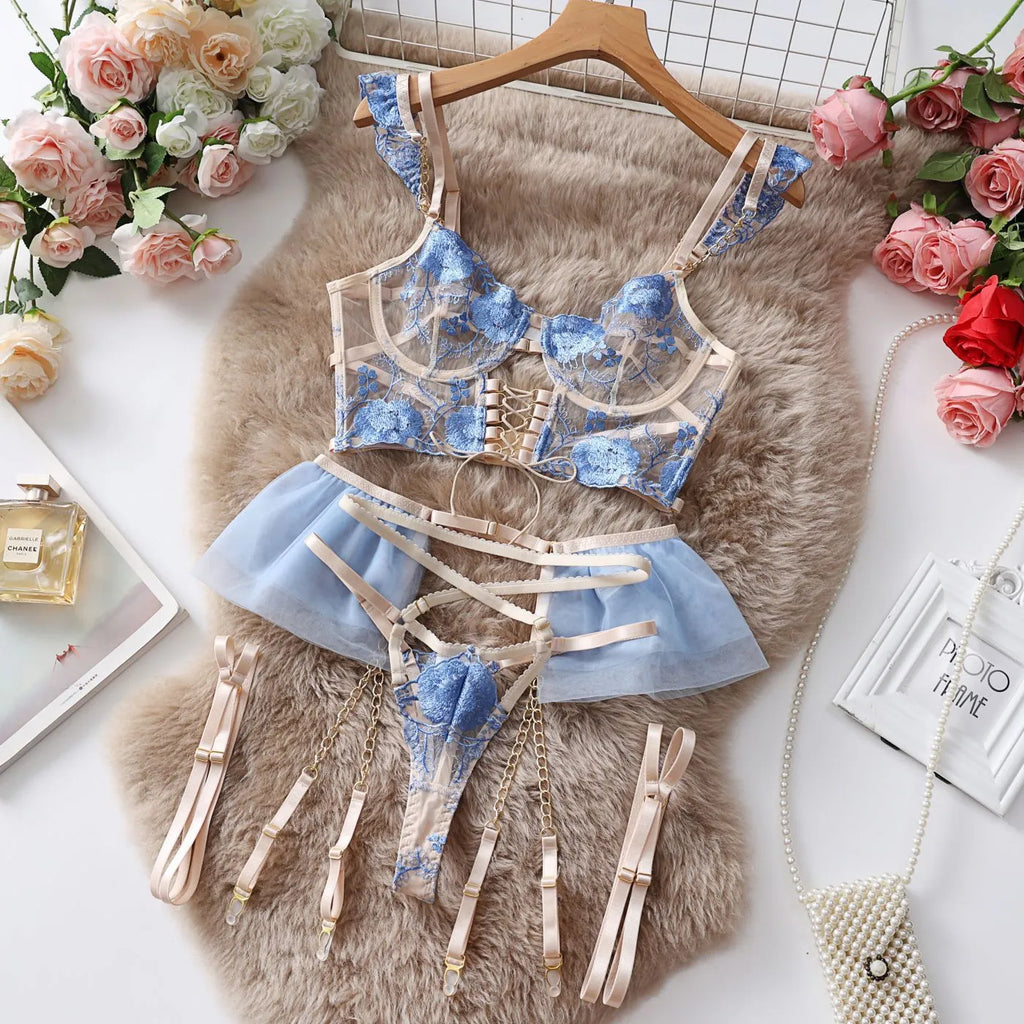 Light blue lace embroidered women's bra and pants set with transparent mesh design.