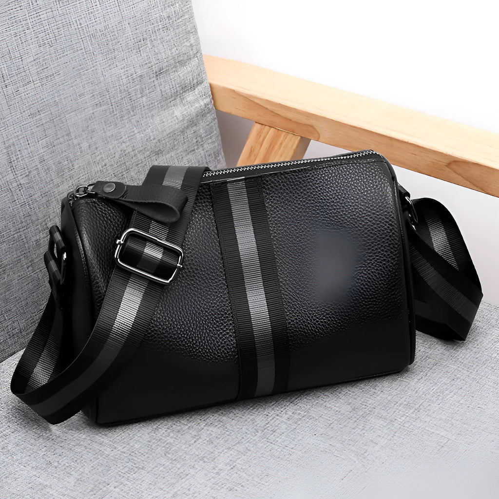 Black genuine leather one-shoulder crossbody bag showing front and strap.