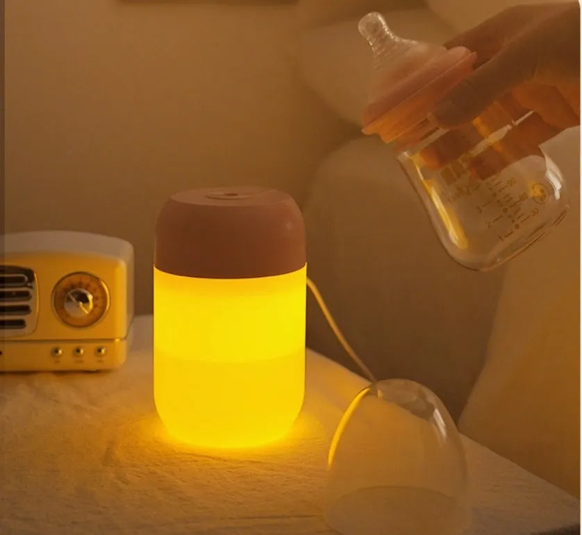 Small white cylindrical USB-powered humidifier with aromatherapy function on a desk