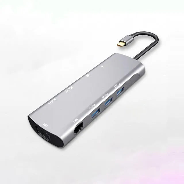 Grey aluminium USB-C docking station with HDMI, VGA, USB 3.0, and charging ports