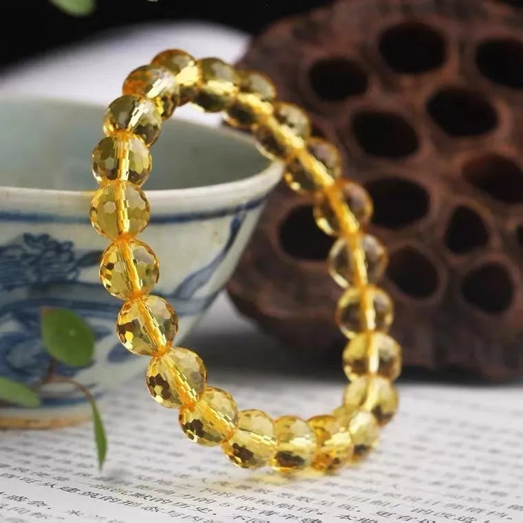 Handmade ametrine bracelet with detailed 128-cut crystal beads on wrist.
