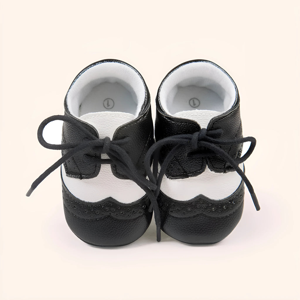 Vintage style soft-soled baby walking shoes in synthetic leather, shown in light brown colour.