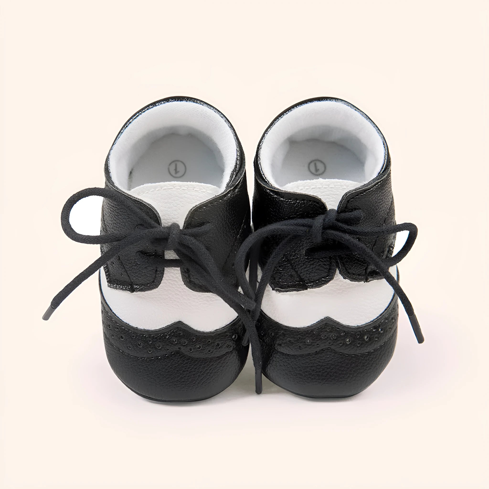 Vintage style soft-soled baby walking shoes in synthetic leather, shown in light brown colour.