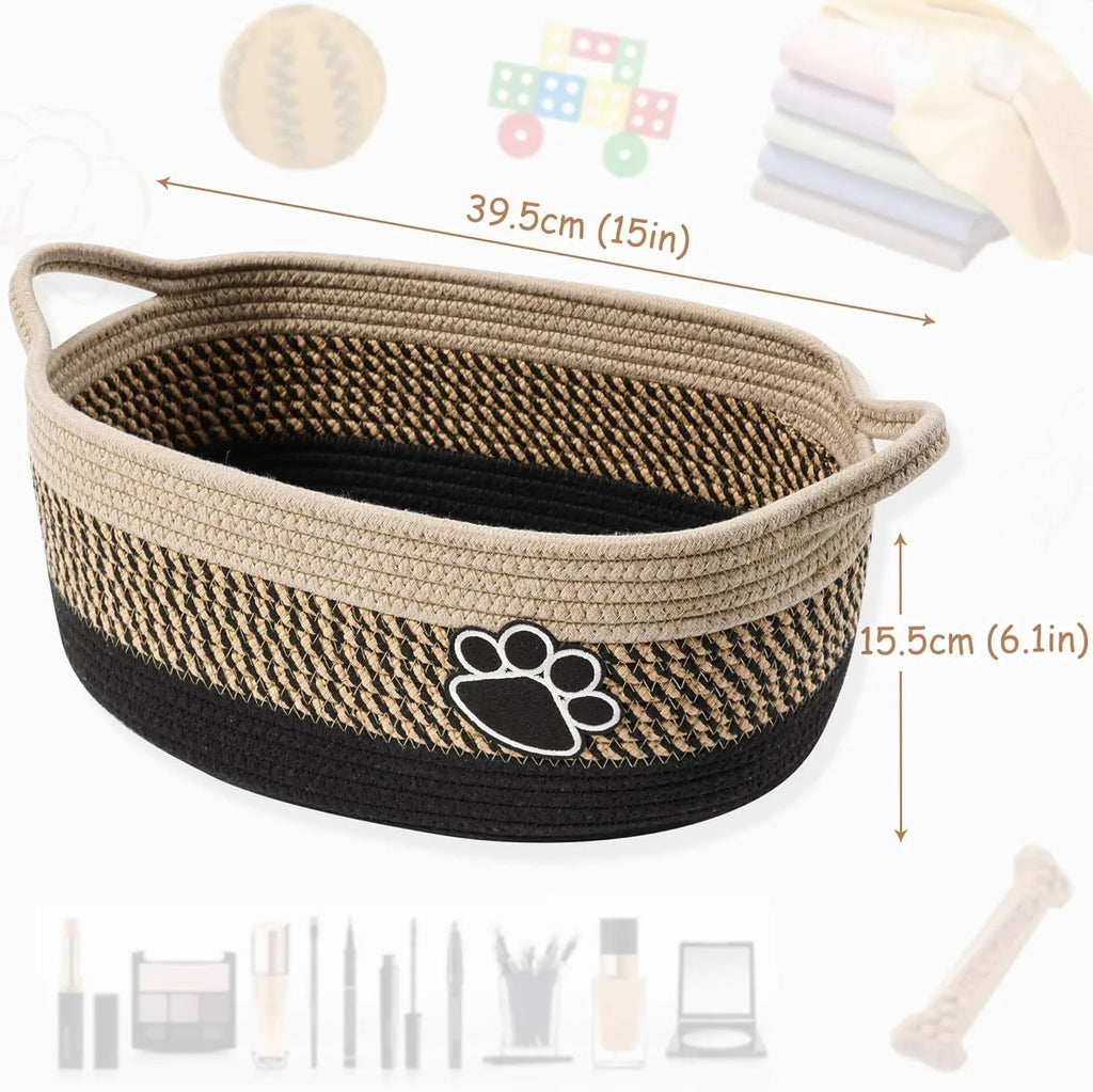 Small light beige woven cotton rope storage basket with handles on a wooden surface.