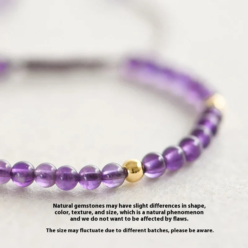 Handmade 4mm natural amethyst bracelet with 14K gold plated accents on a white background
