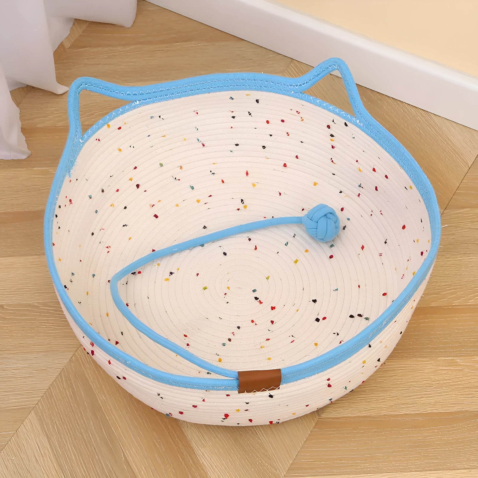 Cotton and hemp rope cat nest mat in large size with dangling toy ball, placed inside a cage