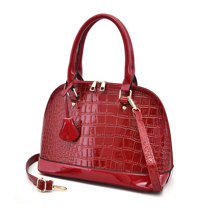 Large shell-shaped shoulder crossbody bag in shiny PU leather with structured silhouette