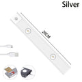 Ultra-thin USB LED night light with motion sensor in silver, aluminium body, 20 cm length, mounted inside a kitchen cabinet