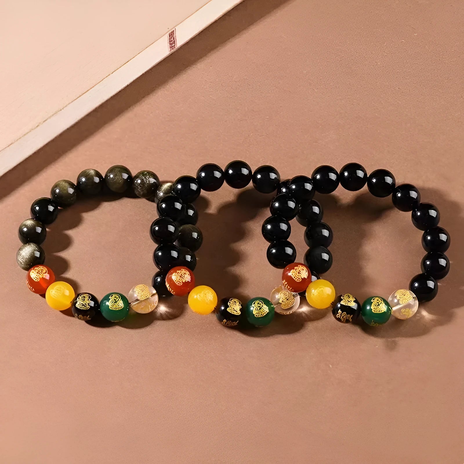 Single circle Five Gods of Wealth rainbow eye obsidian bracelet with polished crystal beads, 10mm size, on white background