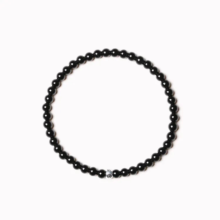 Geometric bracelet with obsidian, blue san and black agate beads showing round and chamfered square designs