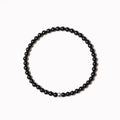 Geometric bracelet with obsidian, blue san and black agate beads showing round and chamfered square designs