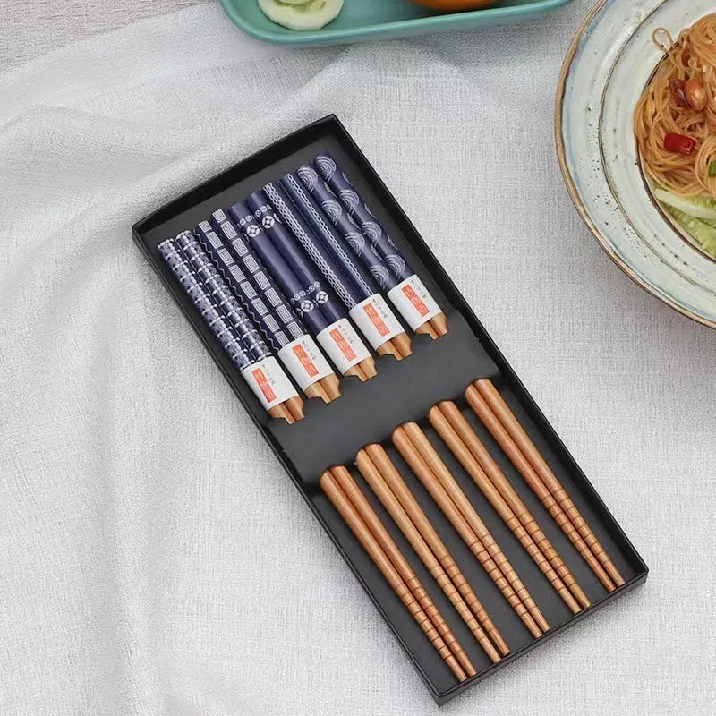 Five pairs of bamboo chopsticks with colourful Japanese lucky cat cartoon design.