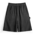 Cement grey polyester sports shorts with straight cut and elastic waistband