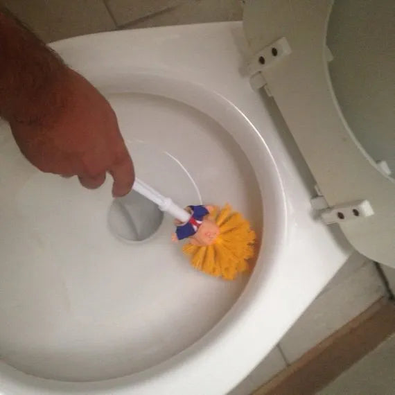 Yellow plastic Donald Trump toilet brush with handle slot, 40cm length, on white background
